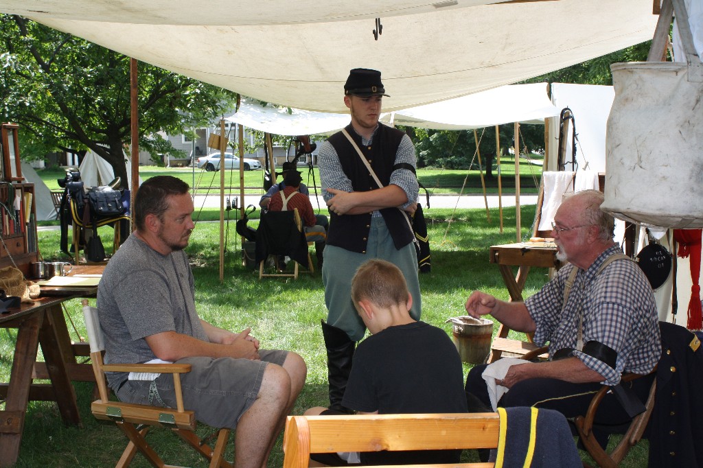 Colonel visits with guests in camp